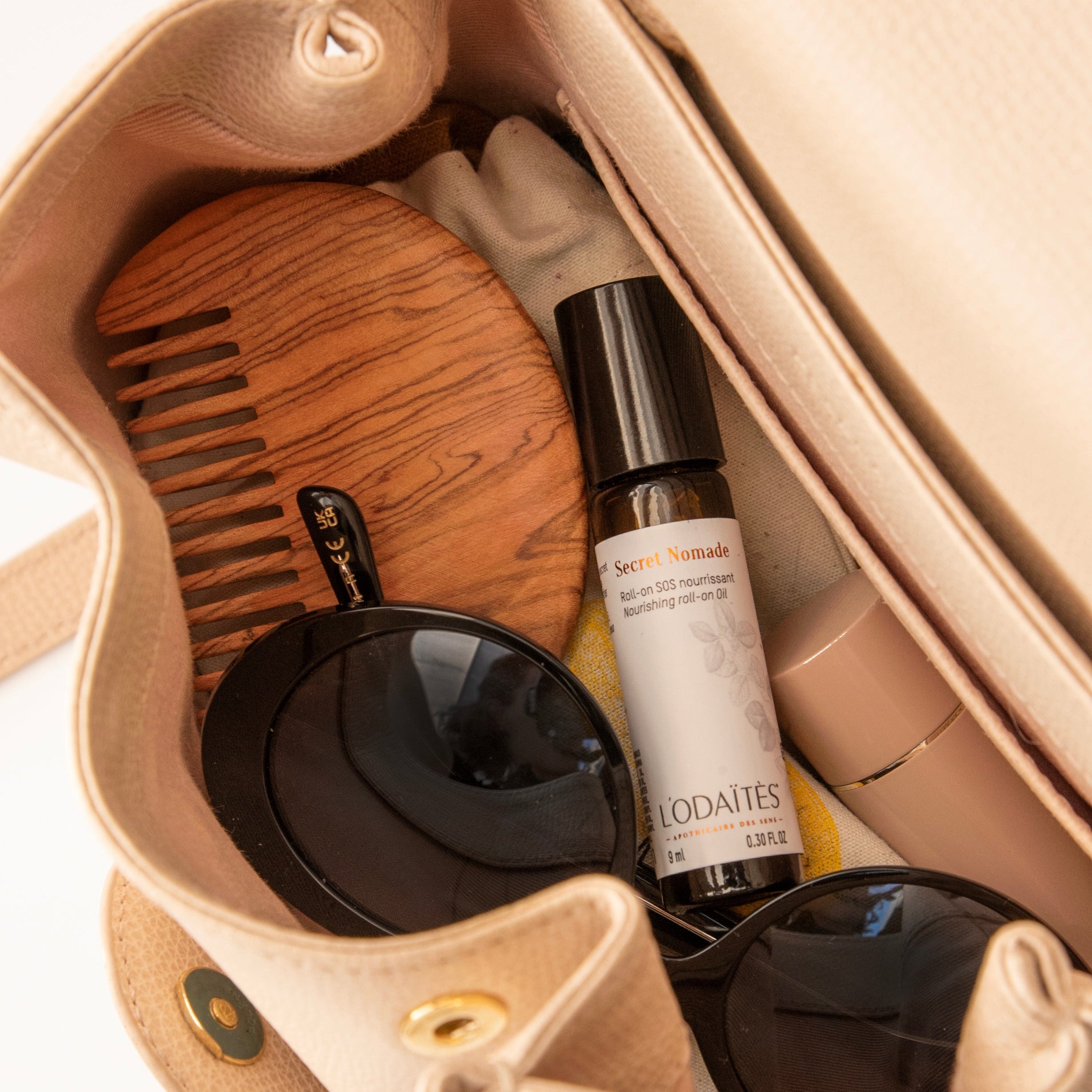 L'Odaïtès nourishing roll-on inside a handbag